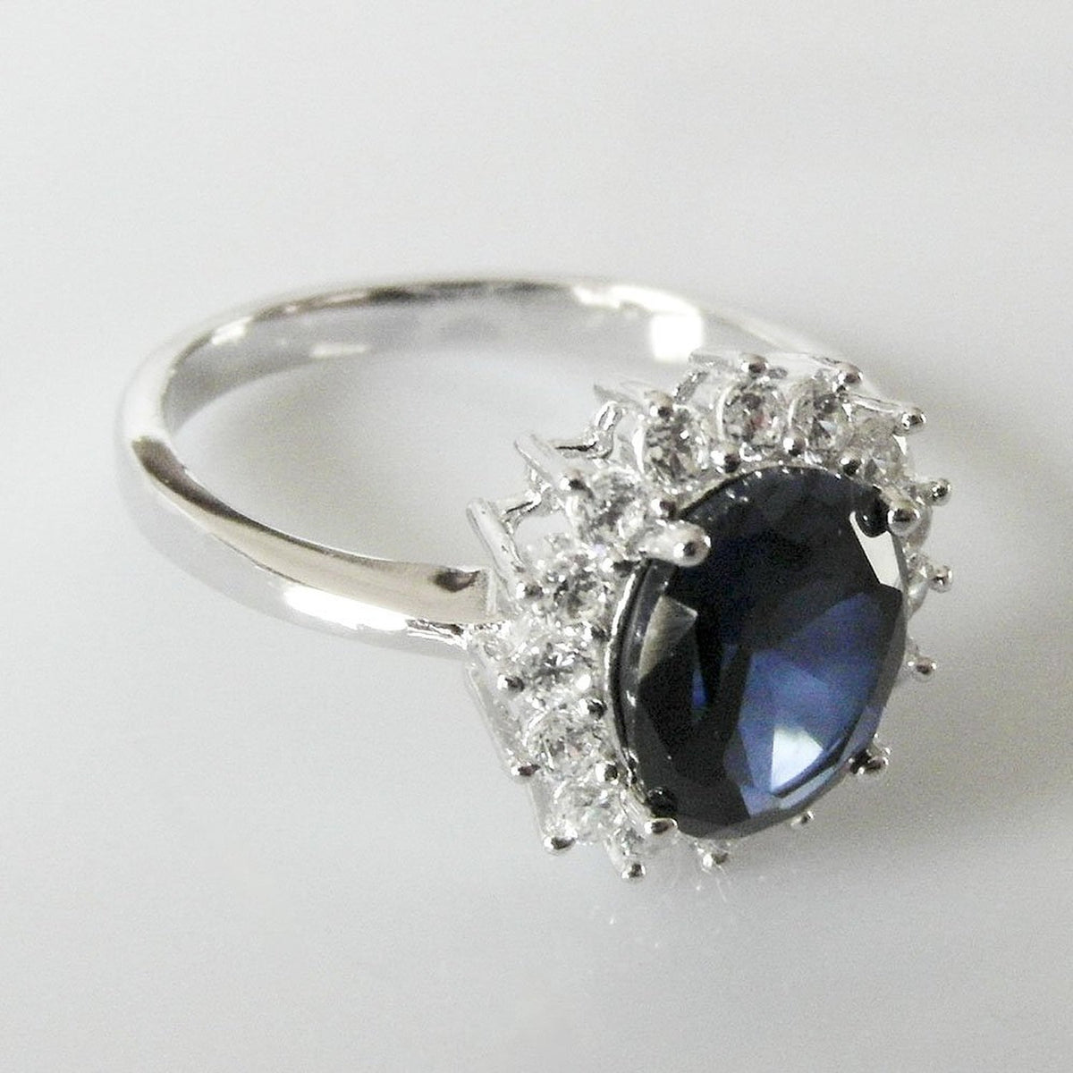 Womens Sterling Silver Blue Synthetic Sapphire & White Cubic Zirconia (CZ) Oval Cluster En 